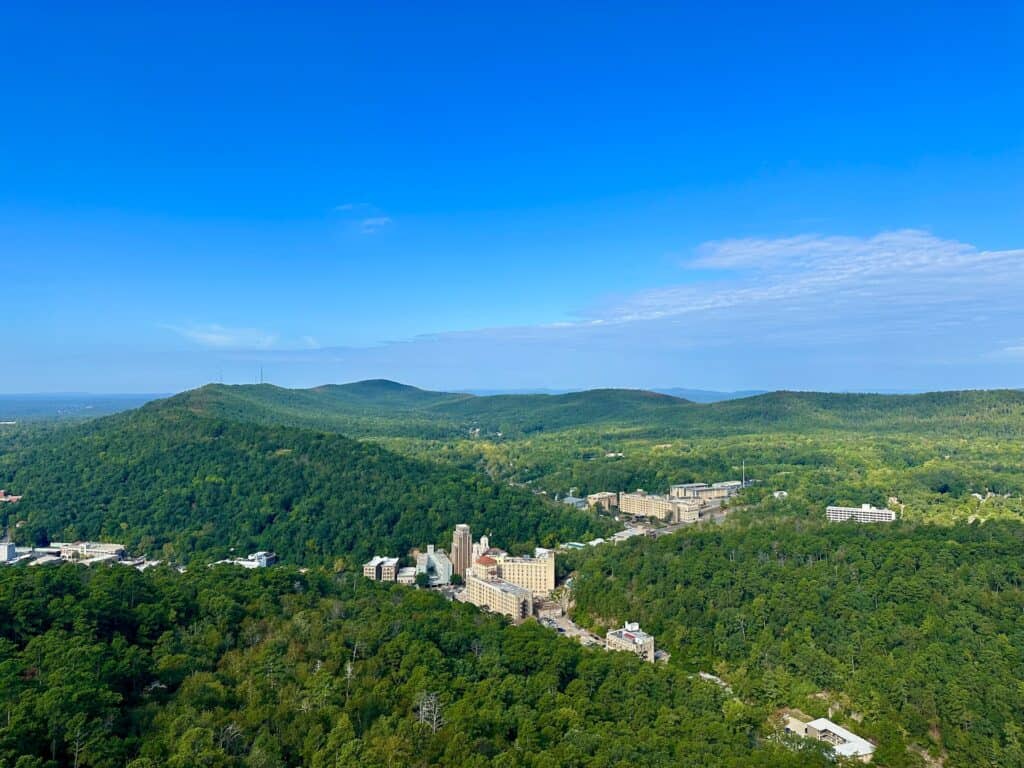 Aerial view of Downtown Hot Springs, Arkansas with blue sky and Ouachita Mountains